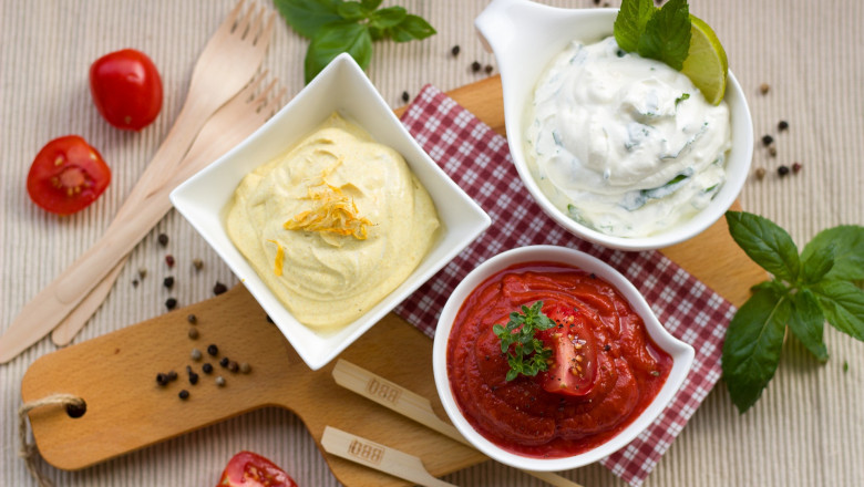 What are the reasons chefs add sauces and condiments to restaurant food?