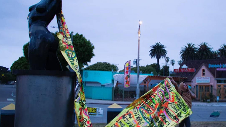 Local Artist Champions Women Rights Cause by Placing a Golden Cape on a Nude Statue at Venice Beach, California